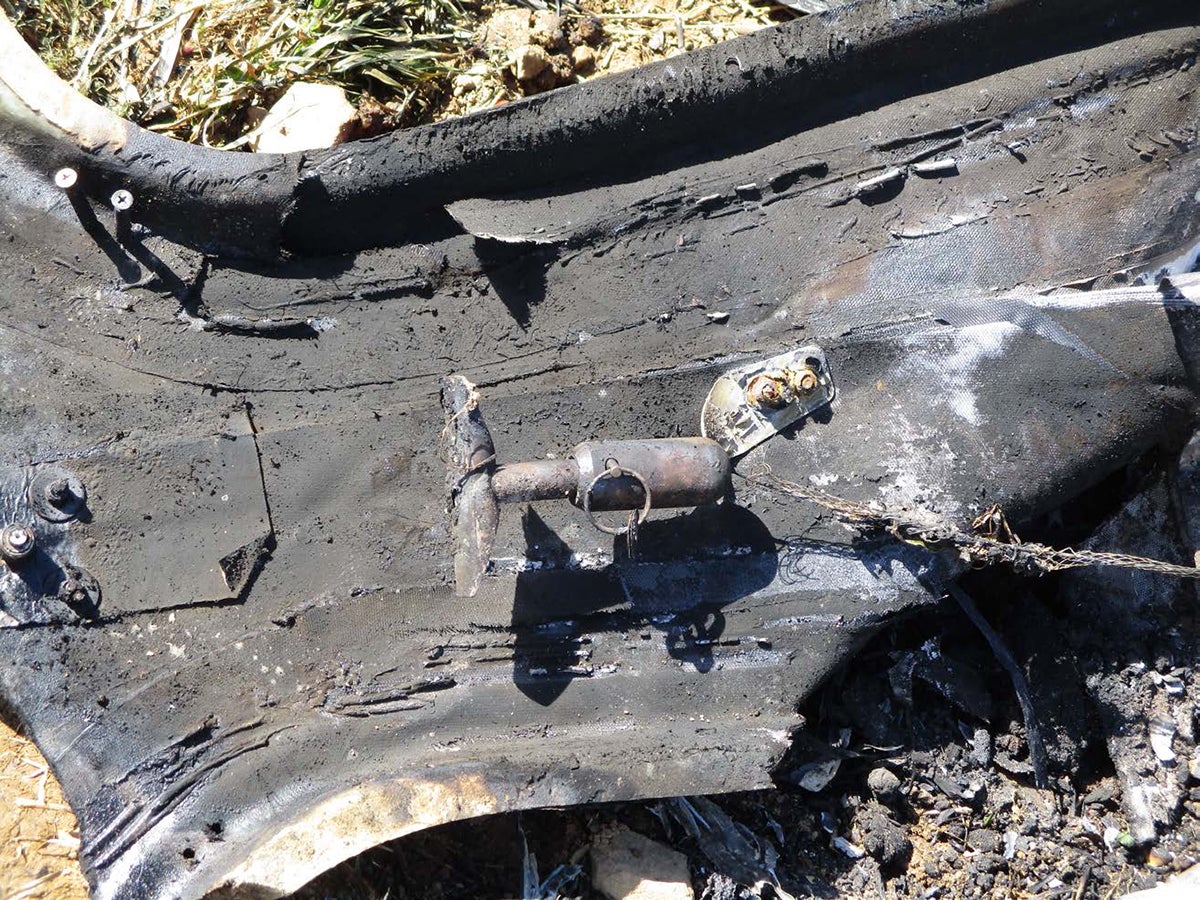 The wreckage of a Cirrus SR22 shows the CAPS handle and safety pin still intact.