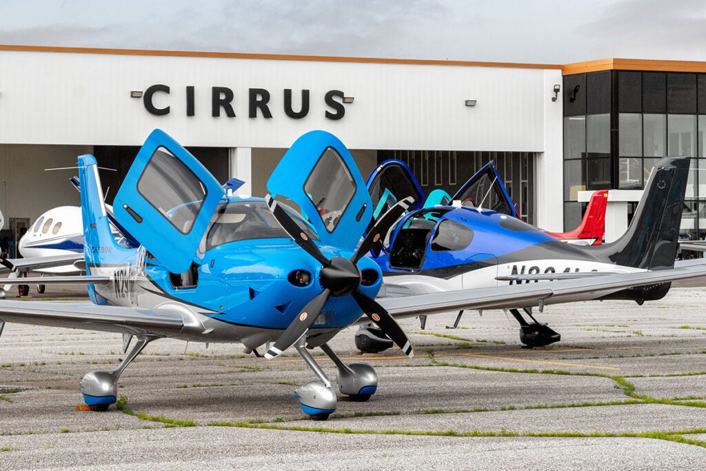 Cirrus Paint Facility with Cirrus aircraft parked in front