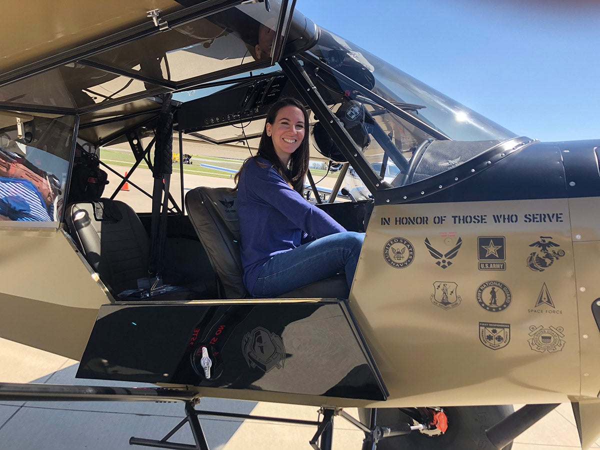 A young woman pictured in the cockpit of an aircraft