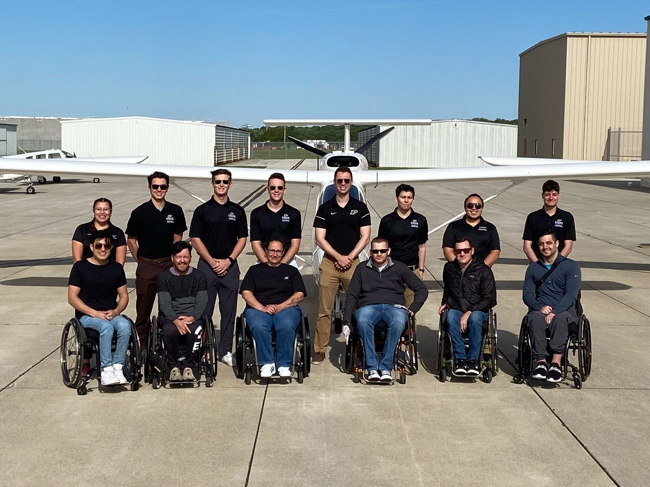 Nathaniel Miller, with Able Flight graduates, class of 2022