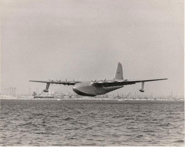 An historic image of the aircraft that would become known as the Spruce Goose, as it starts to lift off the water for its one and only flight.