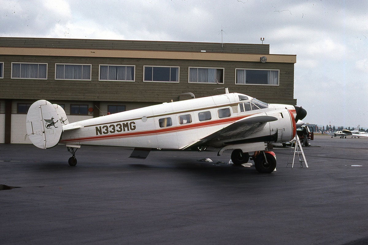 A Beechcraft Super 18 on the tarmac at an airport.