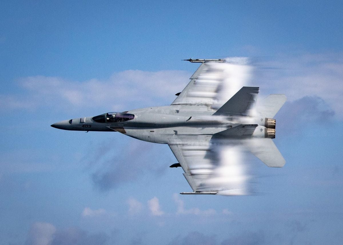 U.S. Navy Lieutenant Commander Benjamin Orloff conducts a supersonic pass in an F/A-18E Super Hornet during a training exercise over the Atlantic Ocean.