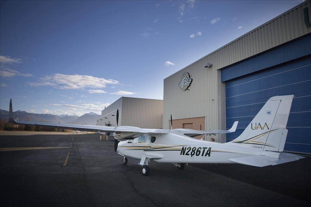 Small plane outside hangar.