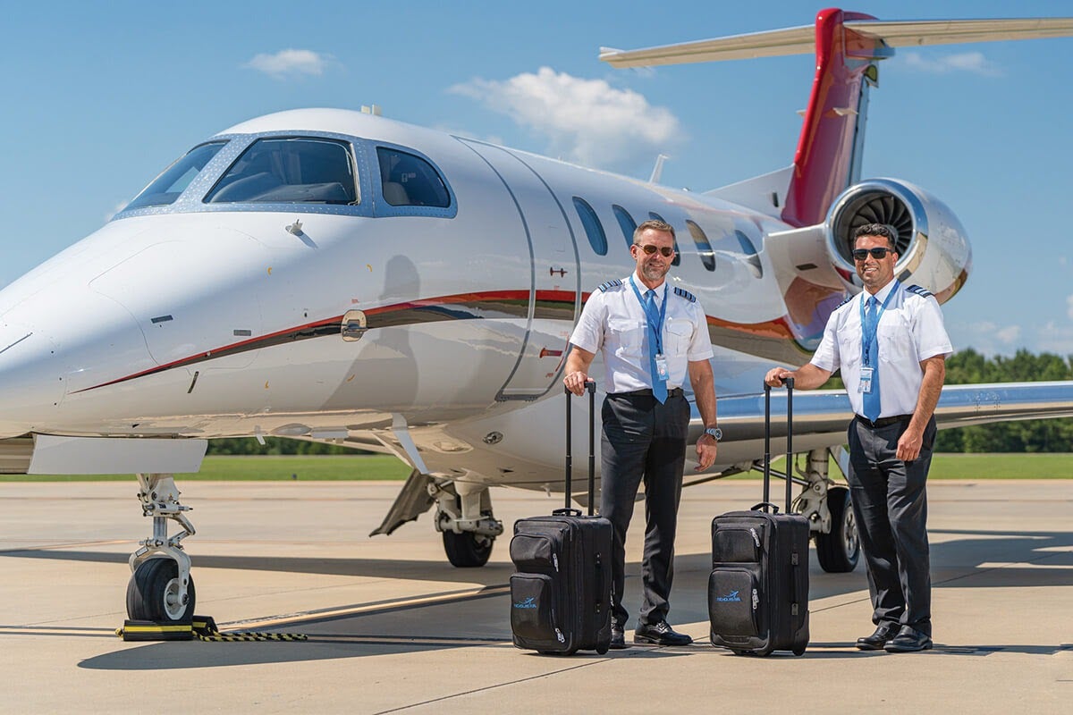Pilots in front of Nicholas Air jet