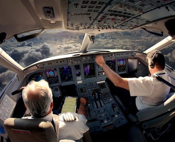 Pilots in an aircraft cockpit.