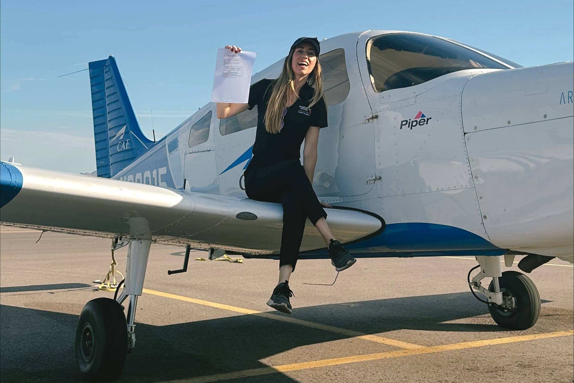 Pilot on wing of aircraft