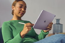 Woman holding an Apple tablet